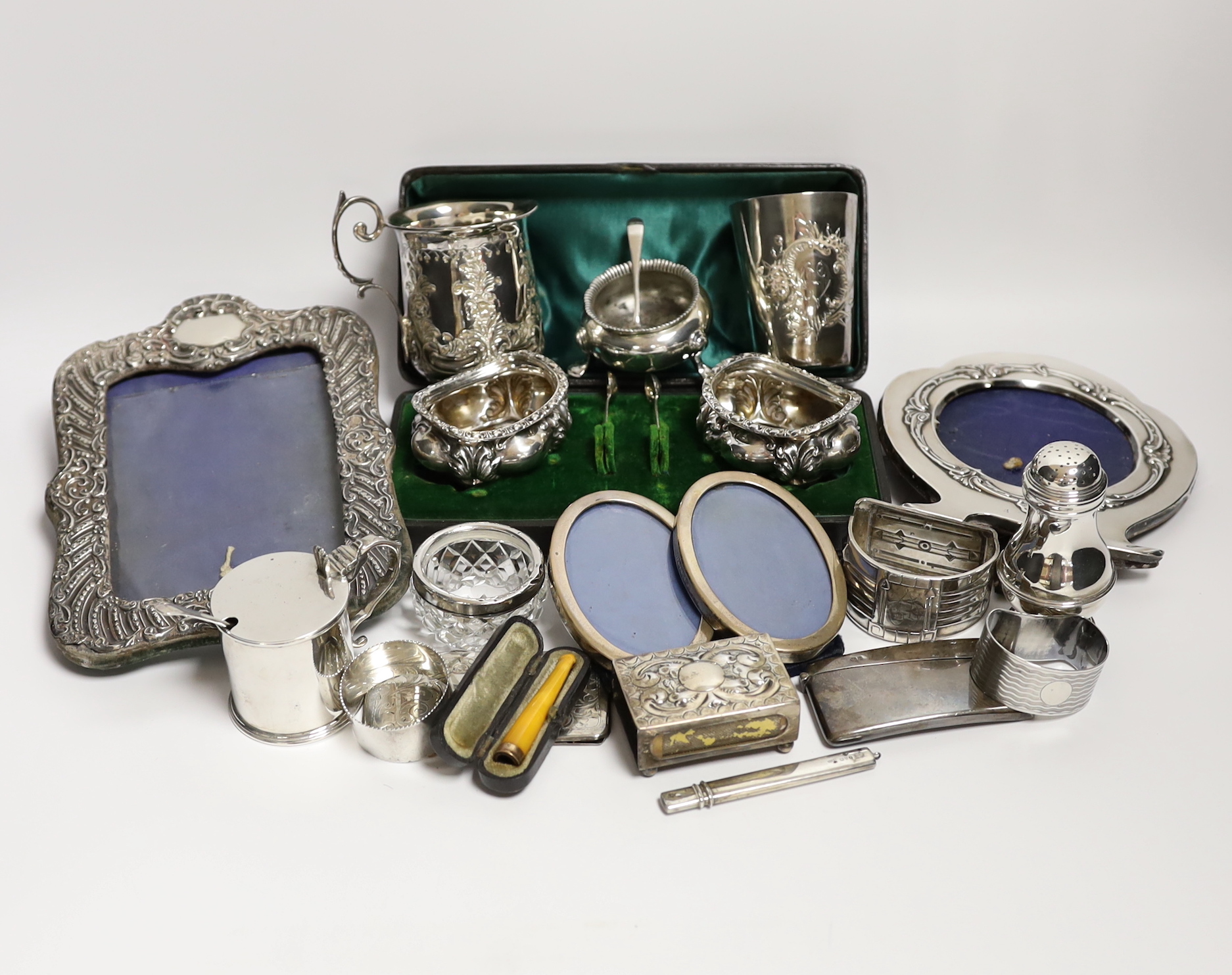 Sundry small silver and white metal items including Edwardian Christening mug, four mounted photograph frames, napkin rings, card cases, bun pepperette etc.